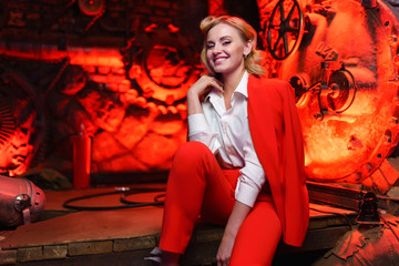 Photo of young blonde in a red jacket in nightclub