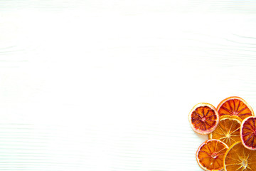Dried sicilian oranges on white wooden table background. Christmas bright colors. Free copy space for greeting. 