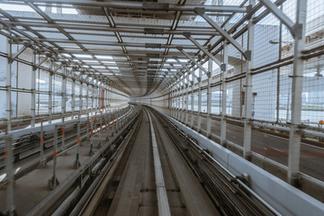 tunnel of monorail road view from front window of a moving train running