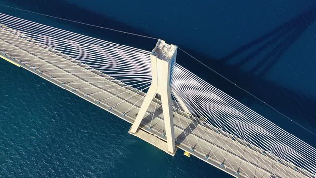 Aerial drone video of world famous cable suspension bridge of Rio - Antirio Harilaos Trikoupis, crossing Corinthian Gulf, mainland Greece to Peloponnese, Patras