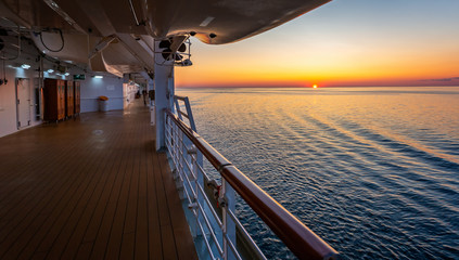 Beautiful sunset and gently lappin waves viewed from the deck of a Cruise Ship on the baltic Sea