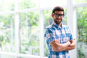 Arab Muslim businessman standing with glass at home office. Work at Home concept