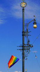LGBT community flag hanging on a lamppost in the center of Prague