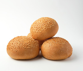 stack of baked whole round bun with sesame seeds made from white wheat flour