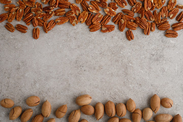 Frame of pecan nuts on marble background.