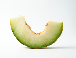 piece of ripe melon with seeds on a white background