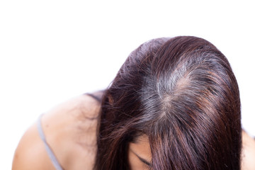 Fototapeta premium Young woman shows her gray hair roots, isolated and white background