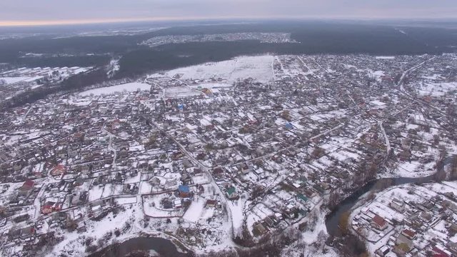small town near the river hills at winter