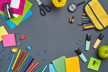 Flat lay photo of workspace desk with school accessories or office supplies.