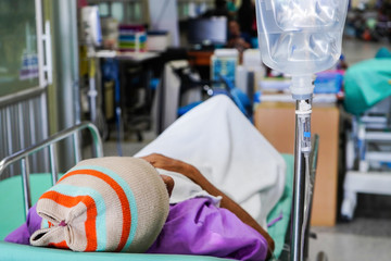 Patient with saline solution drip for treatment in the hospital.