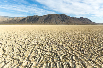 Cracked playa mud texture leading out to the mountains on the Black Rock desert