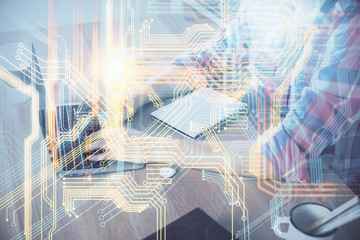 Multi exposure of world map hologram with man working on computer on background. Concept of worldwideweb.