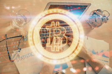 Blockchain theme hologram with man working on computer on background. Concept of crypto chain....