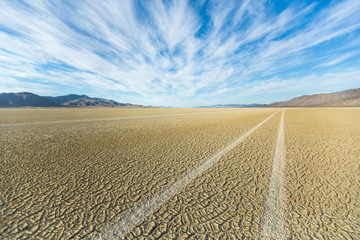Fototapeta na wymiar Tire tracks running across the black rock desert playa