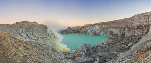 Fototapeta na wymiar Panoramic shot of the Ijen volcano or Kawah Ijen on the Indonesian language. Famous volcano containing the biggest in the world acid lake and sulfur mining spot at the place where volcanic gasses come
