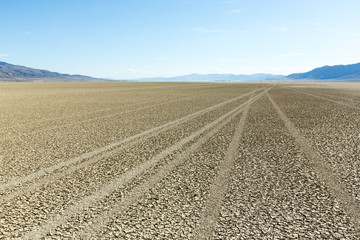 Tire tracks running across the black rock desert playa