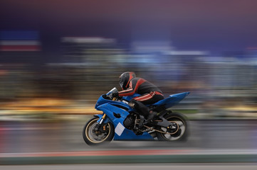Fototapeta na wymiar Motorcycle rider racing at high speed