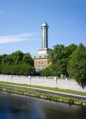 Fototapeta premium Ostravice river, Komenskeho sady park, Ostrava, Czech Republic / Czechia - nature of park in the city center. Tower and building of New Town hall