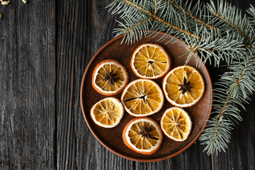 Obraz na płótnie Canvas Christmas decorations, dried orange sliced in round slices, Christmas tree branches