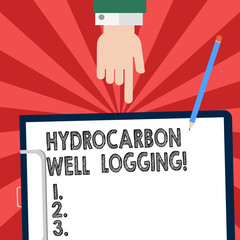 Handwriting text writing Hydrocarbon Well Logging. Concept meaning record of the geologic formations of a borehole Hu analysis Hand Pointing Down to Clipboard with Blank Bond Paper and Pencil