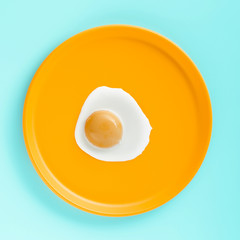 Top view fried egg on yellow plate