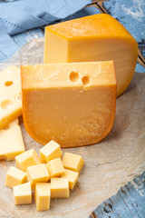 Famous hard cheeses, Dutch Gouda and French Emmentaler in pieces and blocks