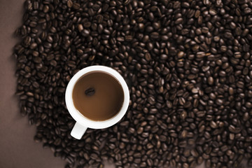 Delicious coffee mug with coffee beans background