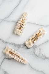 White Pearl Hair clips on marble, group of trendy hair accessories 