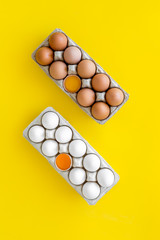 Fresh eggs for organic food on yellow background top view