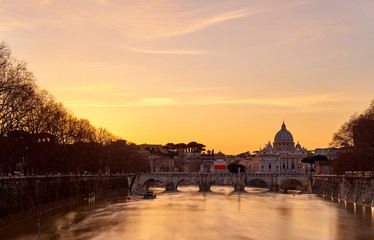 St. Peter's cathedral and Tiber river with high water at  sunset. Saint Peter Basilica in Vatican...