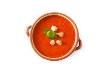 Tomato soup in brown bowl isolated on white background. Top view