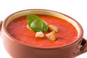Tomato soup in brown bowl isolated on white background. Close up