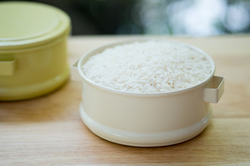 Raw white rice (Thai Jasmine rice) in food carrier (Pinto).