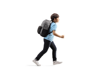 Schoolboy with a backpack running