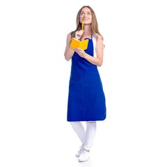 Woman in an apron in the hands of a notebook with a pen cooking recipes on a white background. Isolation