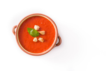 Tomato soup in brown bowl isolated on white background. Top view. Copyspace