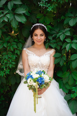 Beautiful bride outdoors in a forest.