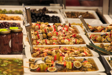 Skewers of olives and anchovies in a market stall in La Boqueria, Barcelona