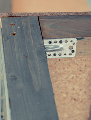 wooden construction with screwed metal angle bracket
