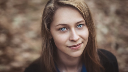 Pretty girl smiling at the camera. Blonde close-up with blue eyes.