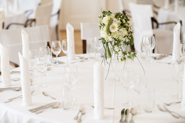 flower decoration on a laid banquet table of a wedding