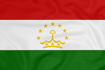 Naklejka premium Flag of Tajikistan on textured fabric. Patriotic symbol