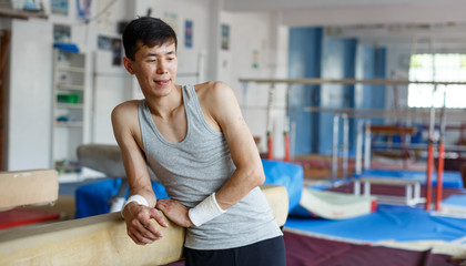 Man posing  in acrobatic hall