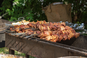 Culinary buffet with takeaway healthy food - meat, pepper, spices, grilled vegetables. Fish and meat on the street, food market, festival, event. Kitchen in the open air.