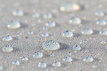 Background design made of water drops on a gray background