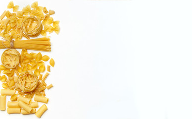 Various uncooked pasta on white background. Top view. Raw pasta with ingredients for cooking. Food concept