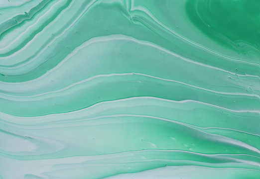 photography of abstract marbleized effect background. emerald, green, mint and white creative colors. Beautiful paint.