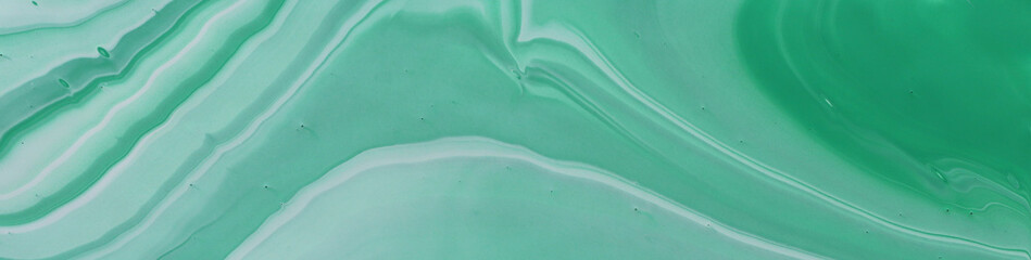 photography of abstract marbleized effect background. emerald, green, mint and white creative colors. Beautiful paint. banner