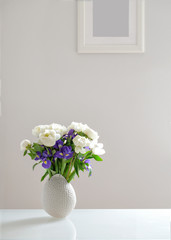 bouquet of white peonies and purple irises
