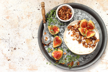 Healthy breakfast with cottage cheese, granola and figs
